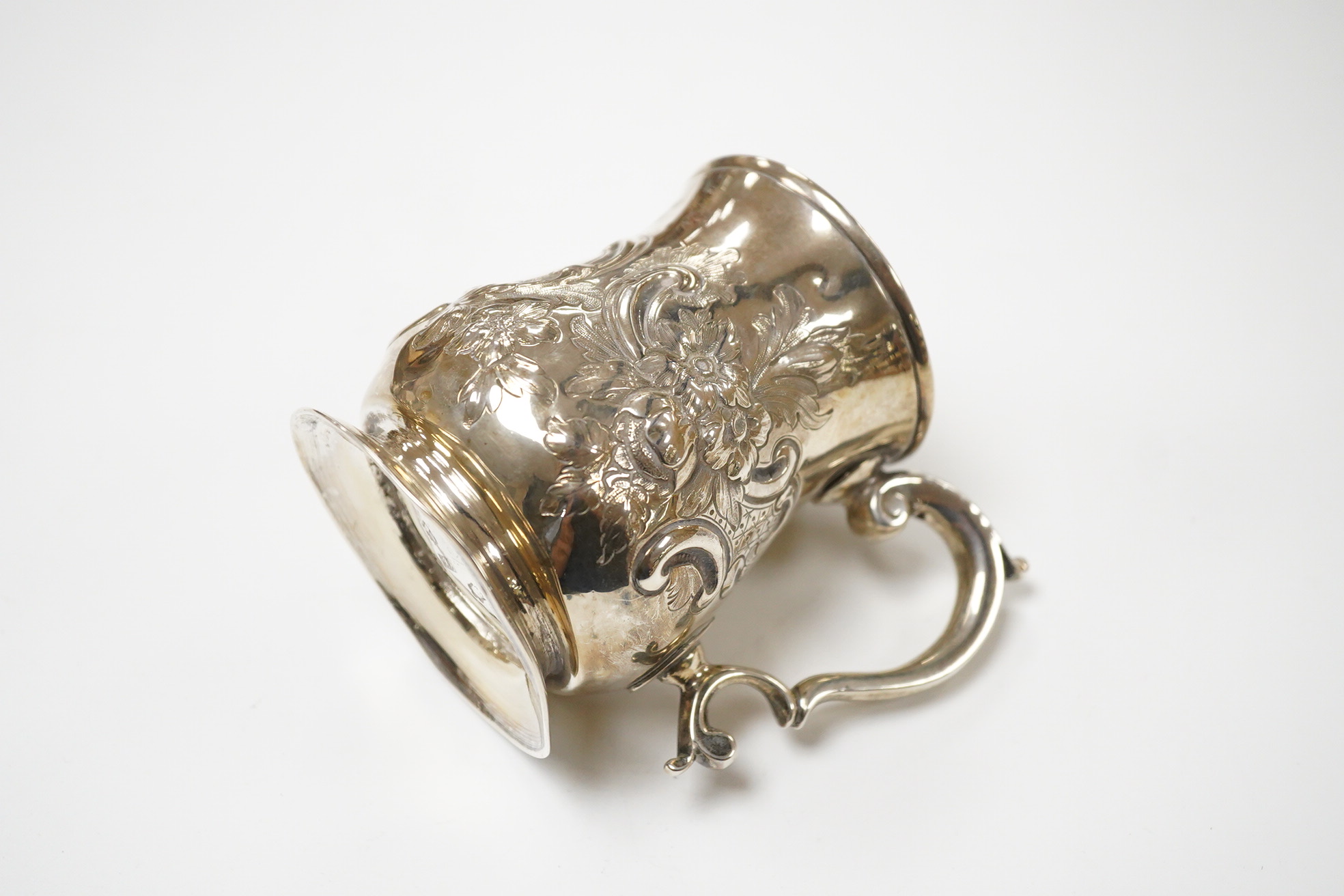 A George II silver baluster mug, by John Bayley, London, 1751, with later embossed decoration, height 95mm, 6.4oz.